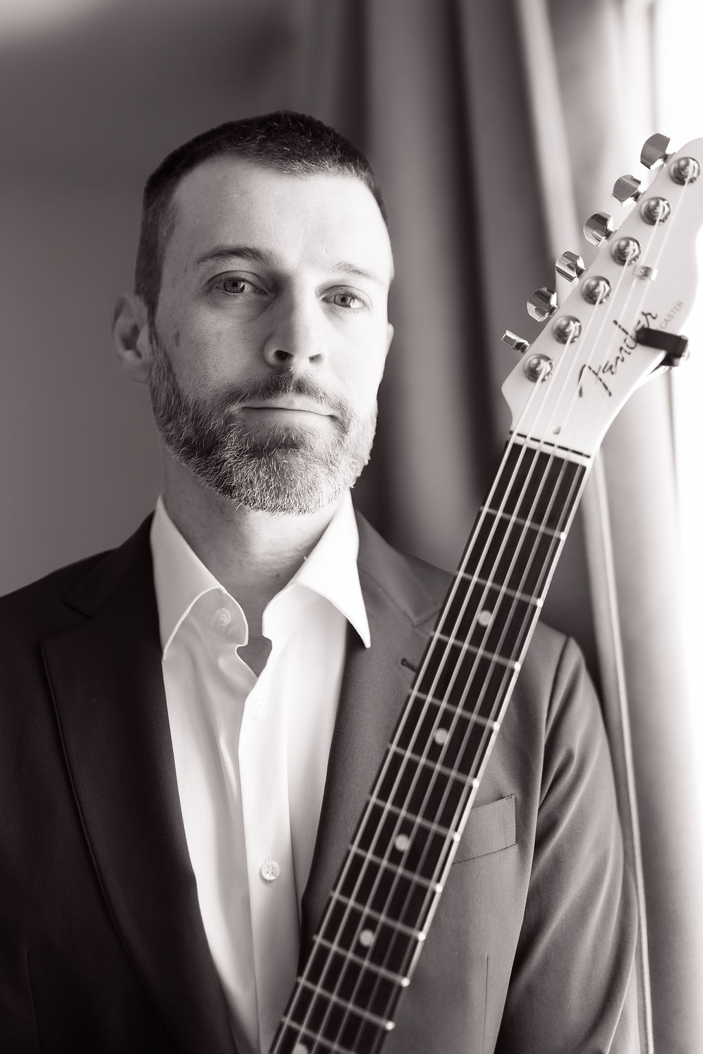 Close-up portrait of Coyah Gamble holding his guitar